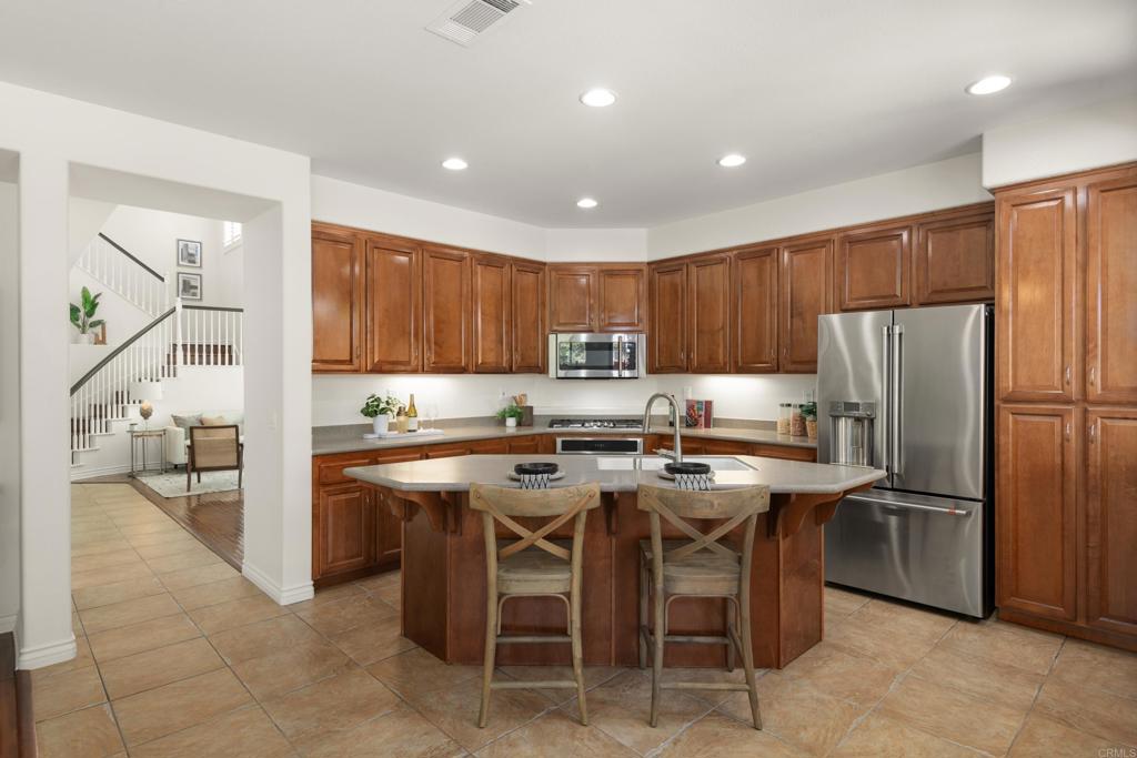5439 Foxtail Loop Carlsbad, CA 92010 - Photo 15 of 47 a kitchen with stainless steel appliances granite countertop a refrigerator and a stove top oven