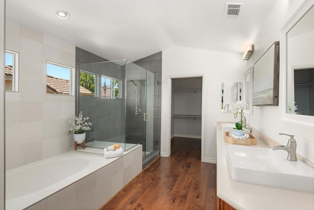 5439 Foxtail Loop Carlsbad, CA 92010 - Photo 23 of 47 a bathroom with a tub sink and mirror