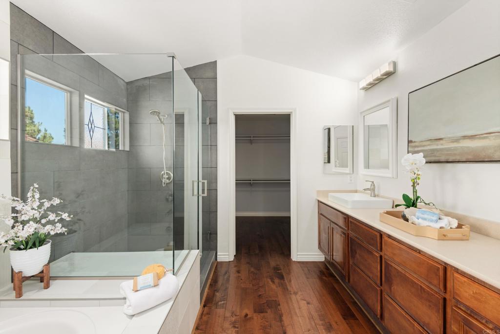 5439 Foxtail Loop Carlsbad, CA 92010 - Photo 24 of 47 a bathroom with a granite countertop sink and a bathtub