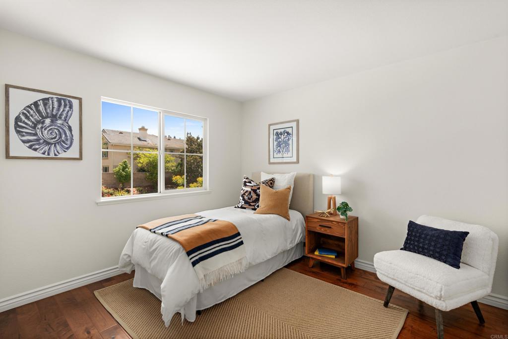 5439 Foxtail Loop Carlsbad, CA 92010 - Photo 28 of 47 a bedroom with a bed and a chair