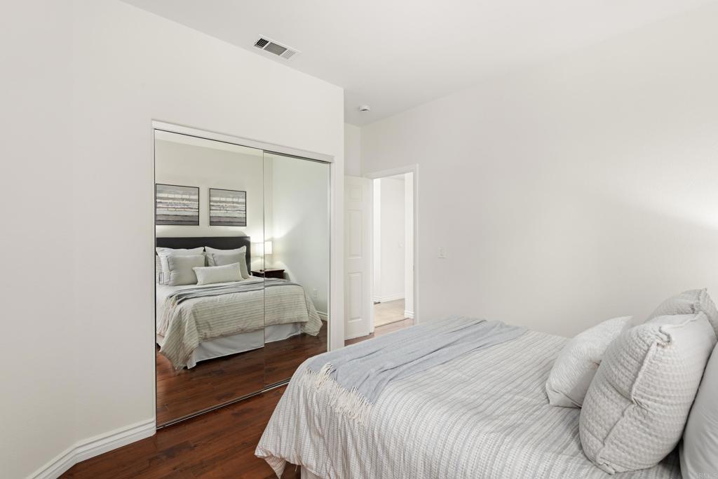 5439 Foxtail Loop Carlsbad, CA 92010 - Photo 32 of 47 a bedroom with a bed and lamp