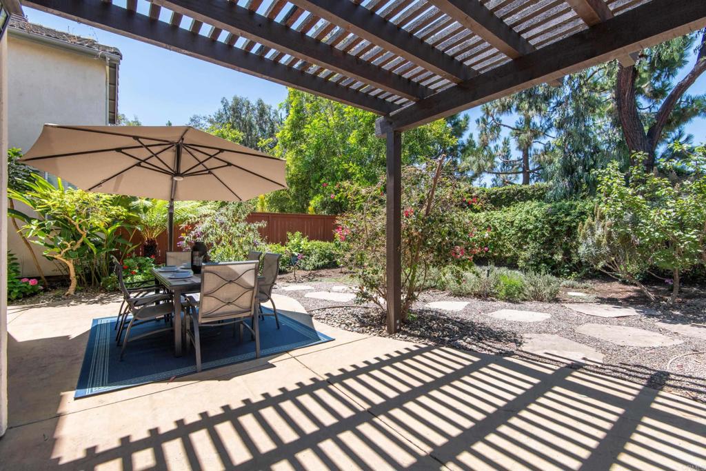 5439 Foxtail Loop Carlsbad, CA 92010 - Photo 37 of 47 a view of a patio with a table chairs and a small yard