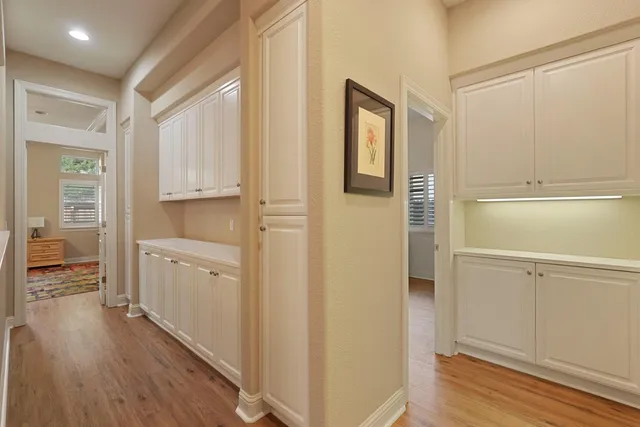 a view of walk in closet with wooden floor