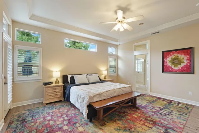 a bedroom with a large bed and a chandelier