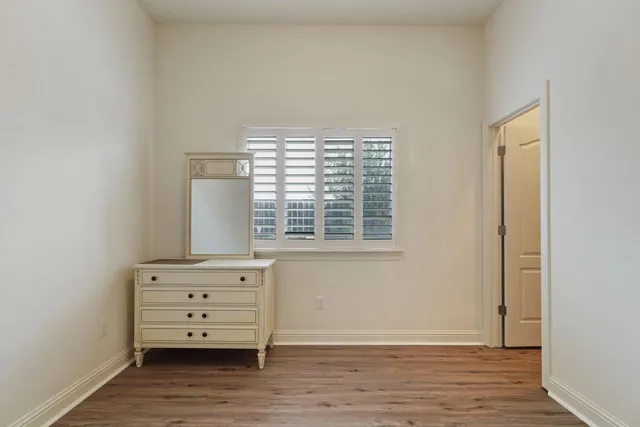 an empty room with wooden floor