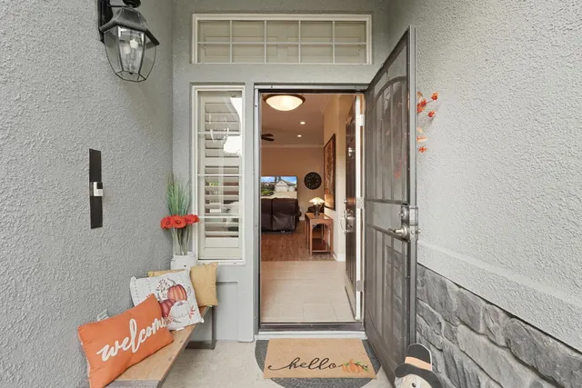 a living room with furniture and a chandelier
