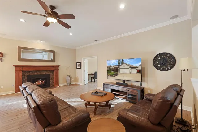 a living room with furniture a table and a fireplace