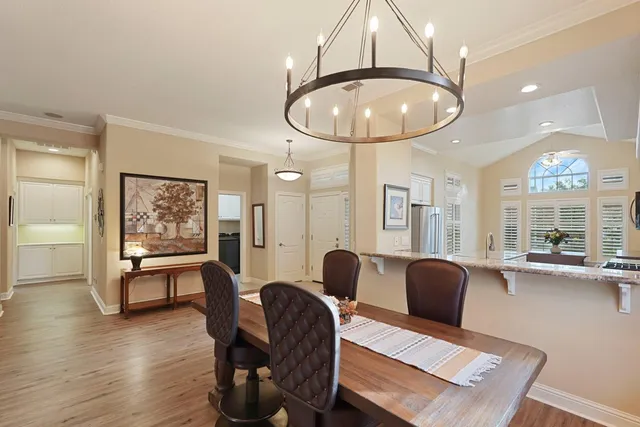 a living room with furniture a dining table and wooden floor