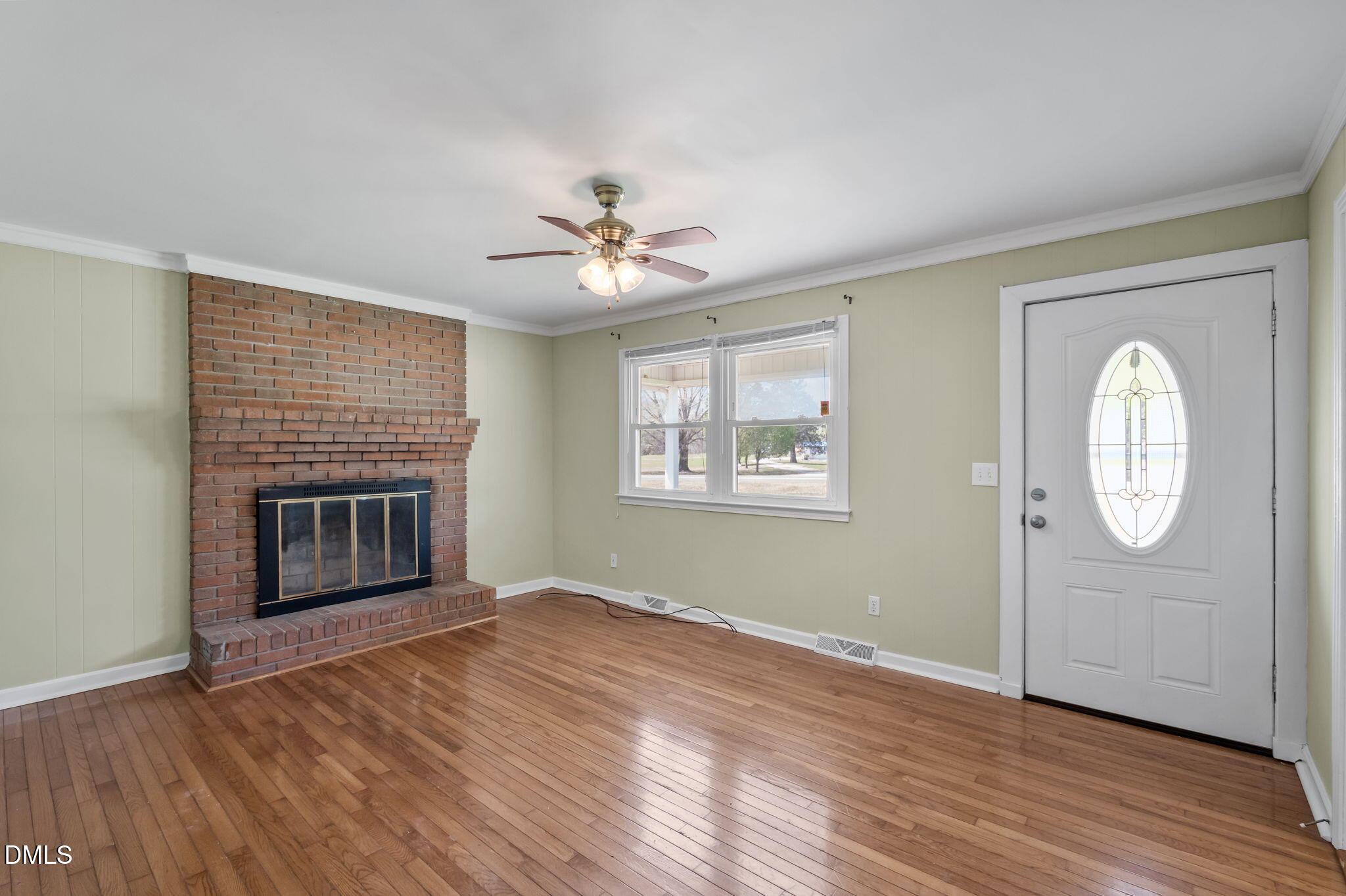 95 Harold Gill Road Roxboro, NC 27574 - Photo 8 of 53 an empty room with windows fireplace and wooden floor