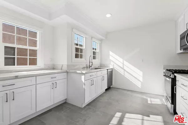 a spacious bathroom with double vanity and a mirror