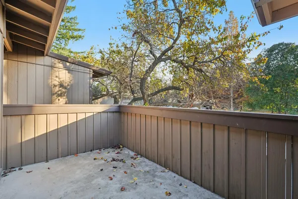 a view of a balcony with wooden floor