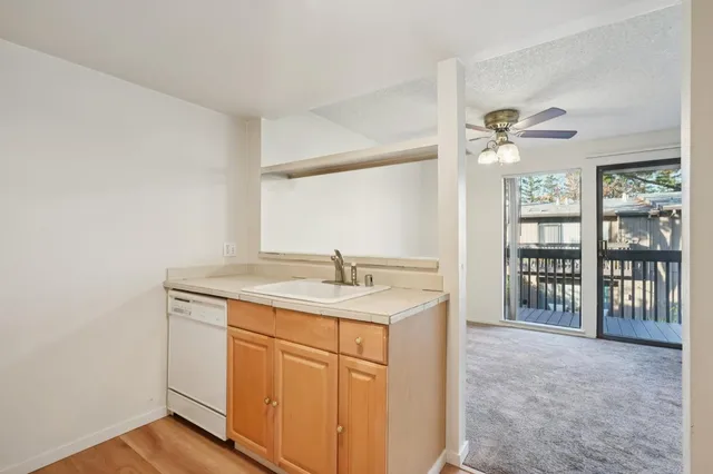 a kitchen with a sink cabinets and a window
