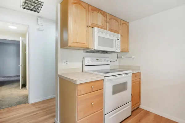 a kitchen with a stove microwave and sink