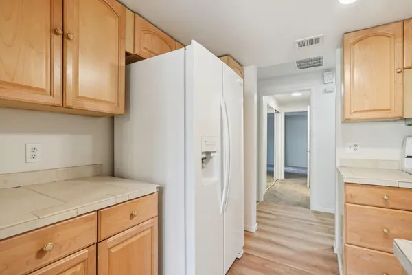 a view of a kitchen from the hallway