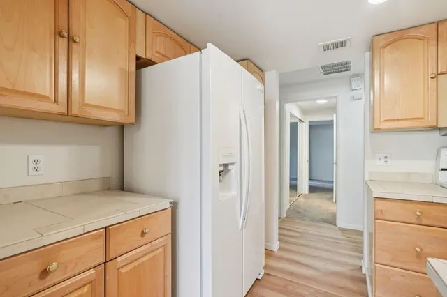 a view of a kitchen from the hallway