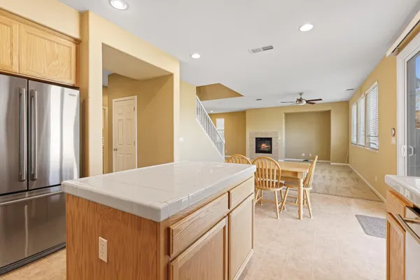 a kitchen with a table chairs and refrigerator