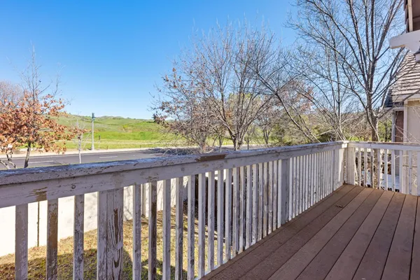 a balcony with wooden floor and fence
