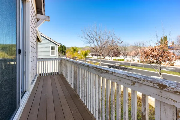 a view of a wooden balcony with a outdoor space