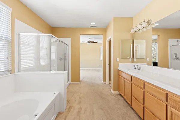 a view of a room with a ceiling fan and a window