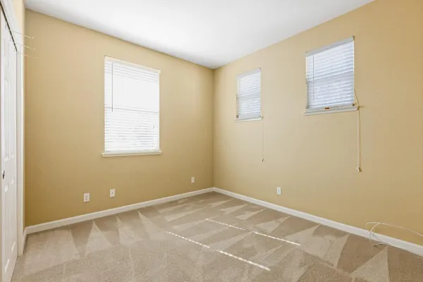an empty room with closet and a bathroom