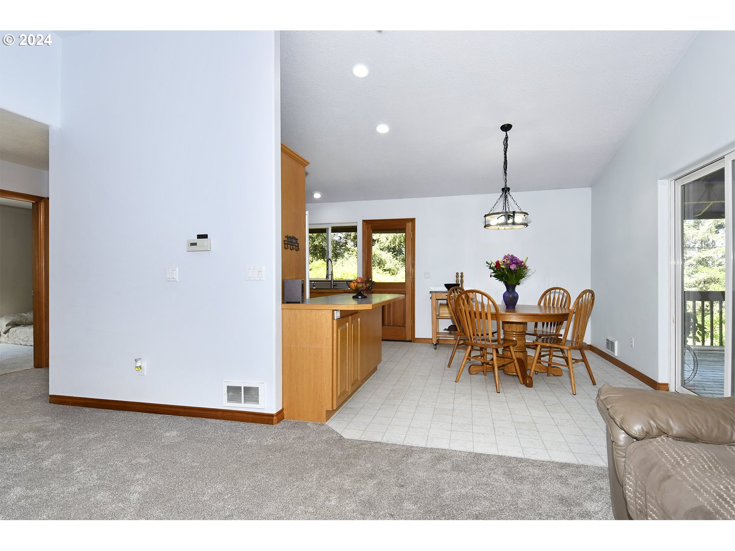 31955 Southeast Compton Road Boring, OR 97009 - Photo 8 of 48 a view of a dining room and livingroom with furniture wooden floor a chandelier