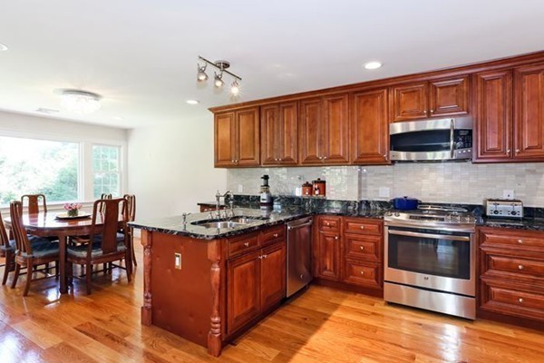 21 Chiltern Road Weston, MA 02493 - Photo 6 of 27 a kitchen with stainless steel appliances granite countertop a stove top oven a sink dishwasher a dining table and chairs with wooden floor