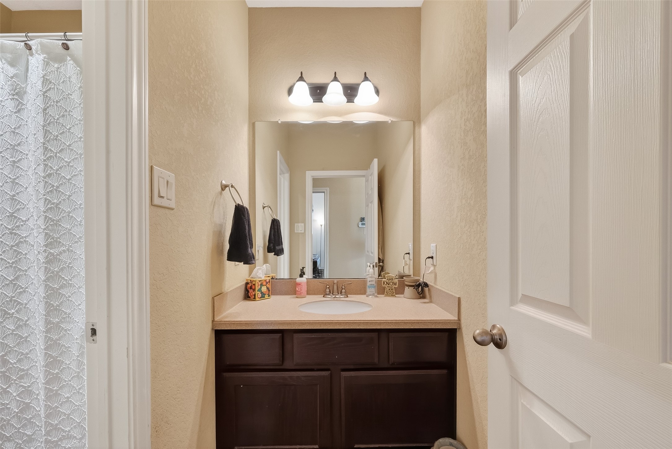 3418 Barbers Hill Road Highlands, TX 77562 - Photo 36 of 50 a bathroom with a sink and a mirror