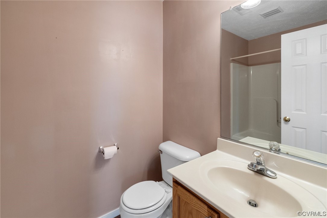 122 Pollard Place Aylett, VA 23009 - Photo 14 of 24 a bathroom with a sink a toilet and mirror