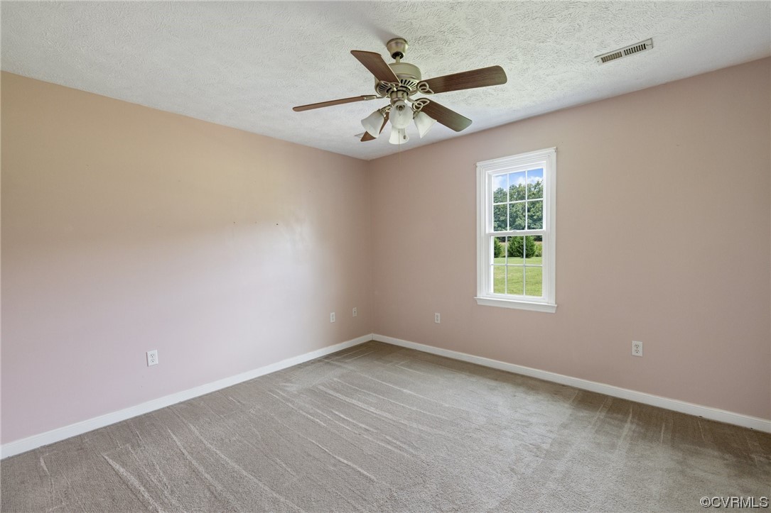 122 Pollard Place Aylett, VA 23009 - Photo 17 of 24 an empty room with a window and a fan