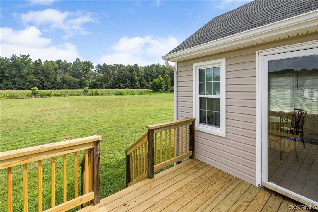 122 Pollard Place Aylett, VA 23009 - Photo 22 of 24 a view of a wooden deck with a lake