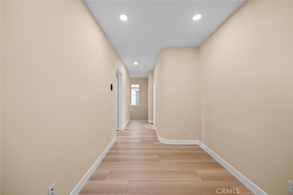 143 Rodeo Irvine, CA 92602 - Photo 33 of 37 a view of a hallway with wooden floor
