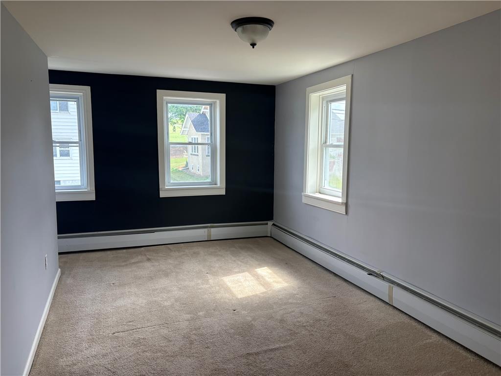 7281 Decatur Street New Tripoli, PA 18066 - Photo 13 of 27 Well-lit room with warm carpeting and a unique two-toned wall design.