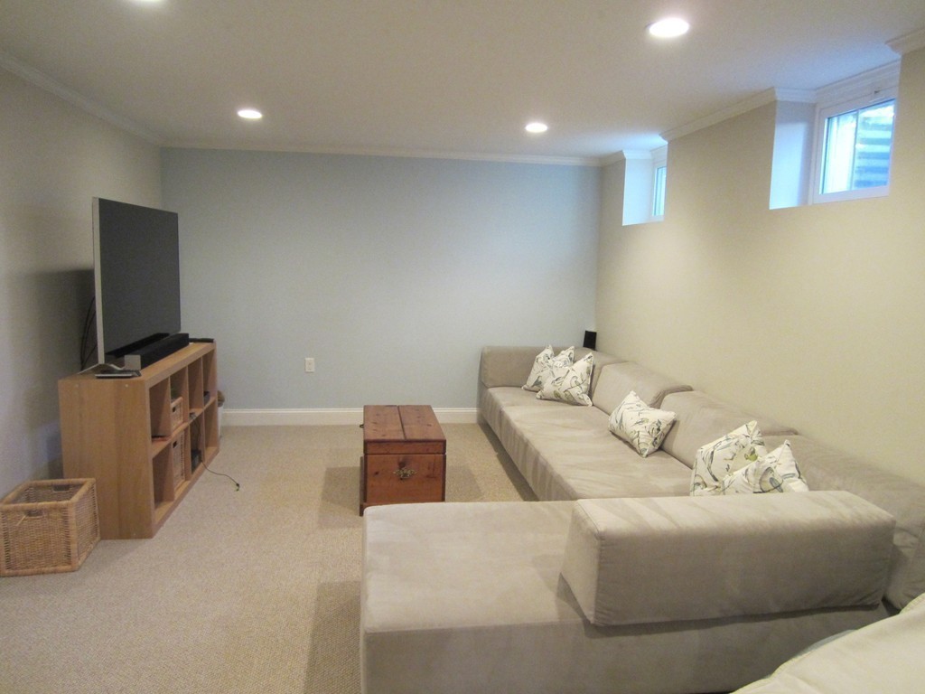 28 Fuller Brook Road Wellesley, MA 02482 - Photo 23 of 28 a living room with furniture and a flat screen tv
