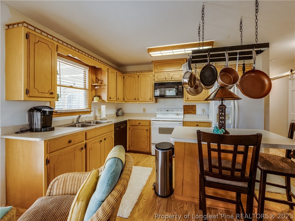 2947 Smith Mill Road Lumberton, NC 28358 - Photo 15 of 50 a kitchen with stainless steel appliances granite countertop a stove a sink and a refrigerator