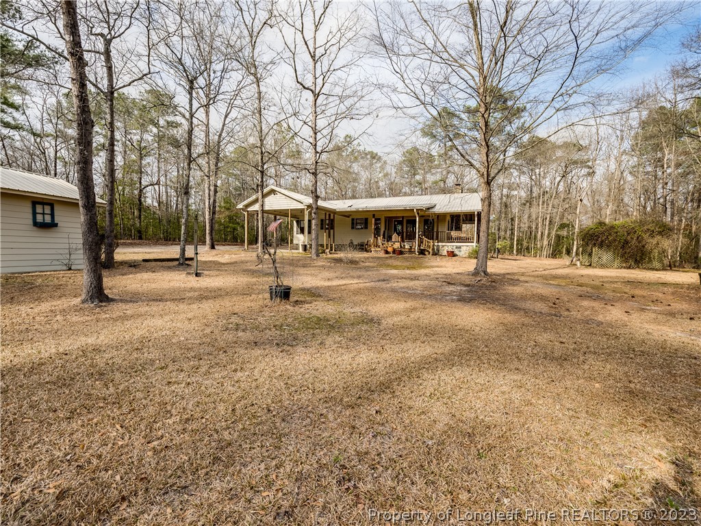 2947 Smith Mill Road Lumberton, NC 28358 - Photo 33 of 50 a front view of residential houses with yard and trees