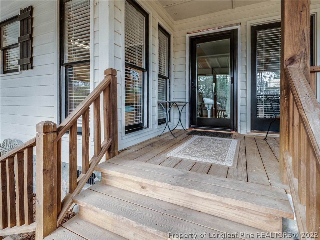 2947 Smith Mill Road Lumberton, NC 28358 - Photo 6 of 50 a view of a balcony with wooden floor and fence