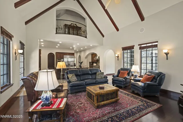 a spacious bedroom with a bed a couch and large window