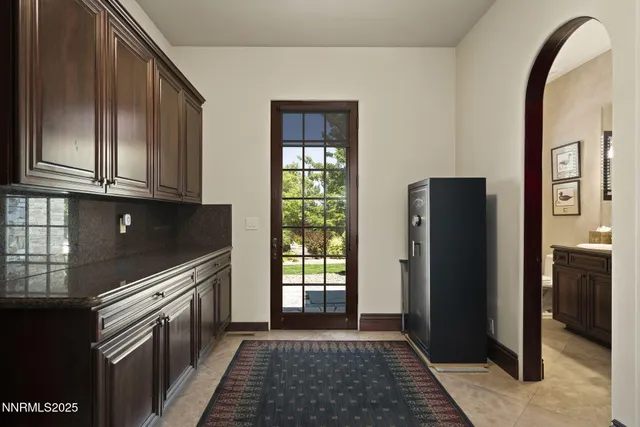 a living room with furniture a chandelier and a flat screen tv