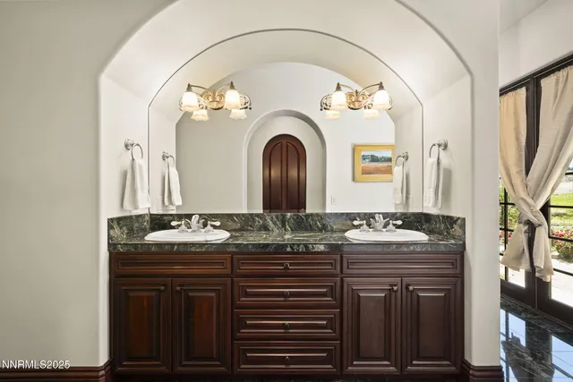 a bathroom with a granite countertop sink toilet a mirror and shower