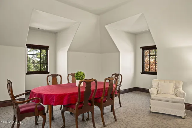 a view of a patio with table and chairs potted plants and a large tree