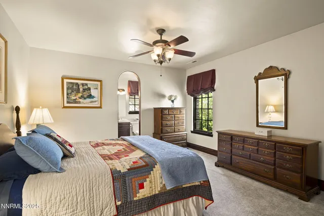 a front view of a house with a yard and a tree