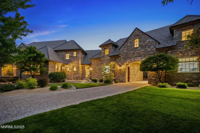 a front view of a house with a yard and a garage