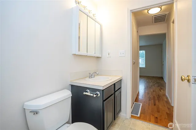 a bathroom with a sink toilet and vanity