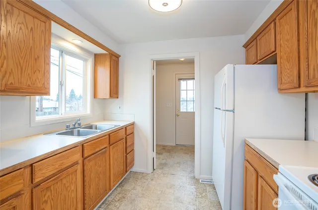 a kitchen with a refrigerator and a sink