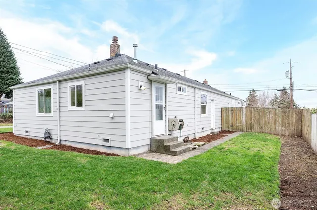 a backyard of a house with table and chairs