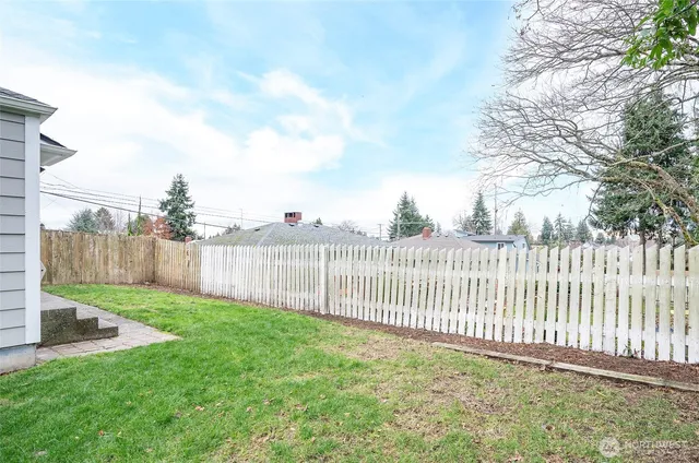 a view of a backyard with a fence