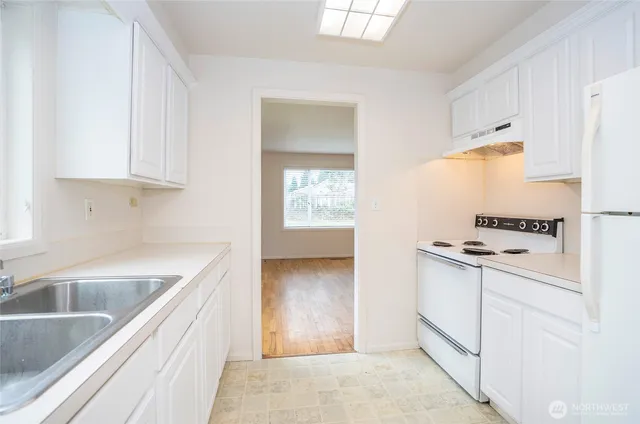 a kitchen with granite countertop a sink and a stove