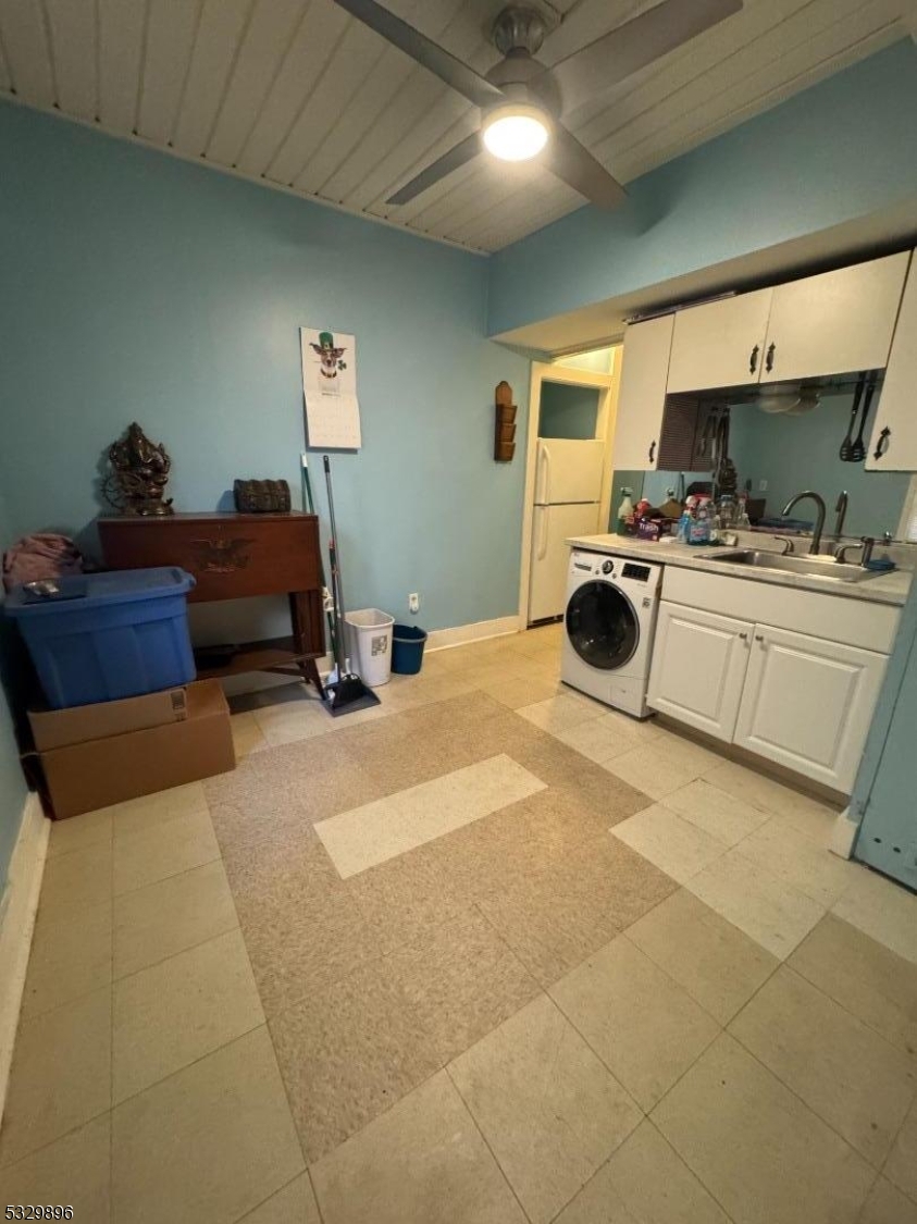 107 Mechanic Street, Unit 9 Boonton, NJ 07005 - Photo 8 of 12 a room with a bed a flat screen tv and kitchen view