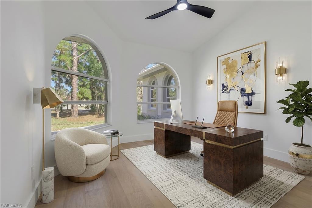 440 33rd Avenue Northeast Naples, FL 34120 - Photo 12 of 34 a living room with furniture a large window and a flat screen tv