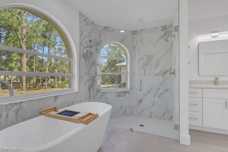 440 33rd Avenue Northeast Naples, FL 34120 - Photo 15 of 34 a bathroom with a tub a sink and a window